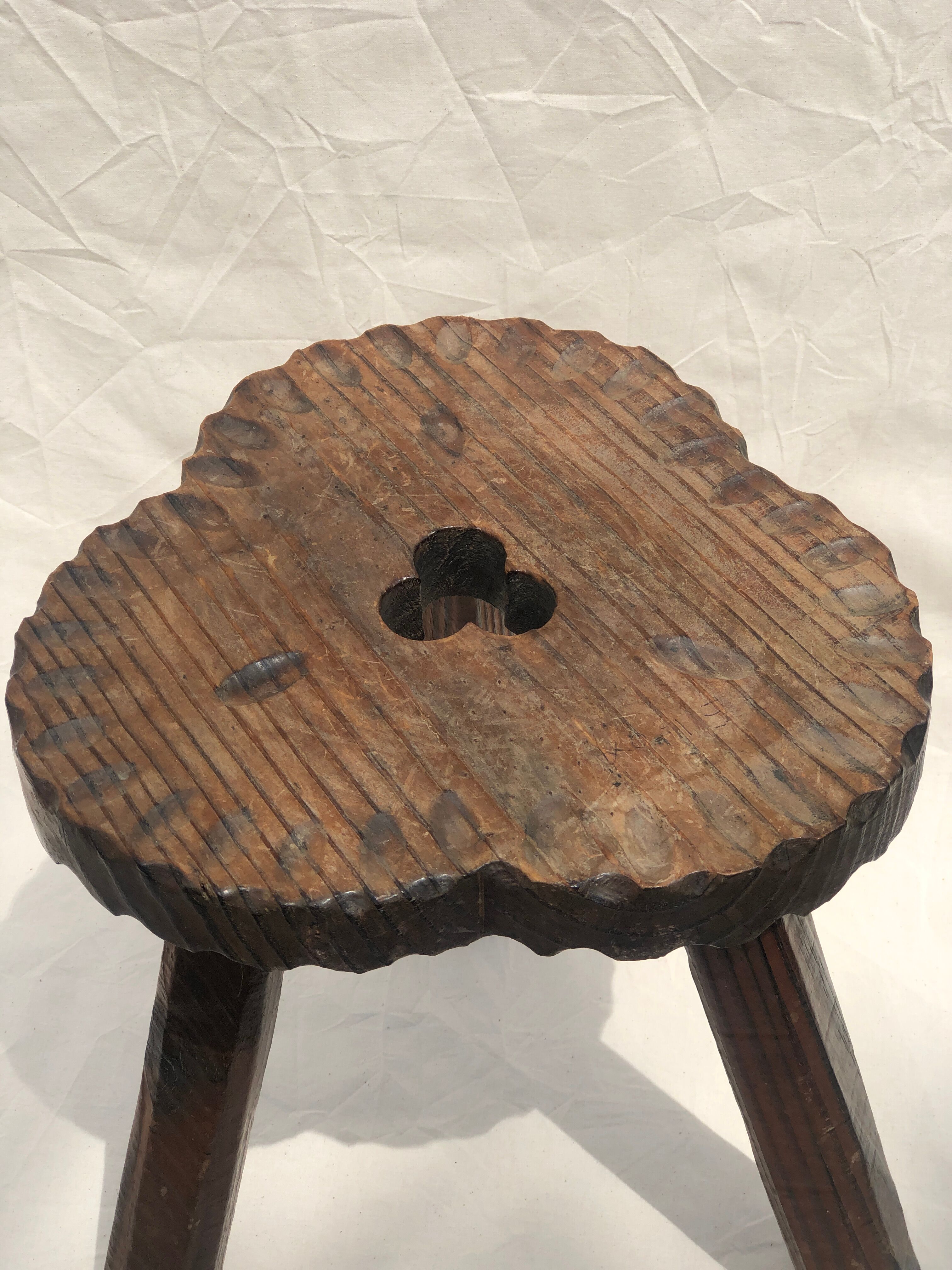 Chiseled wooden tripod stool