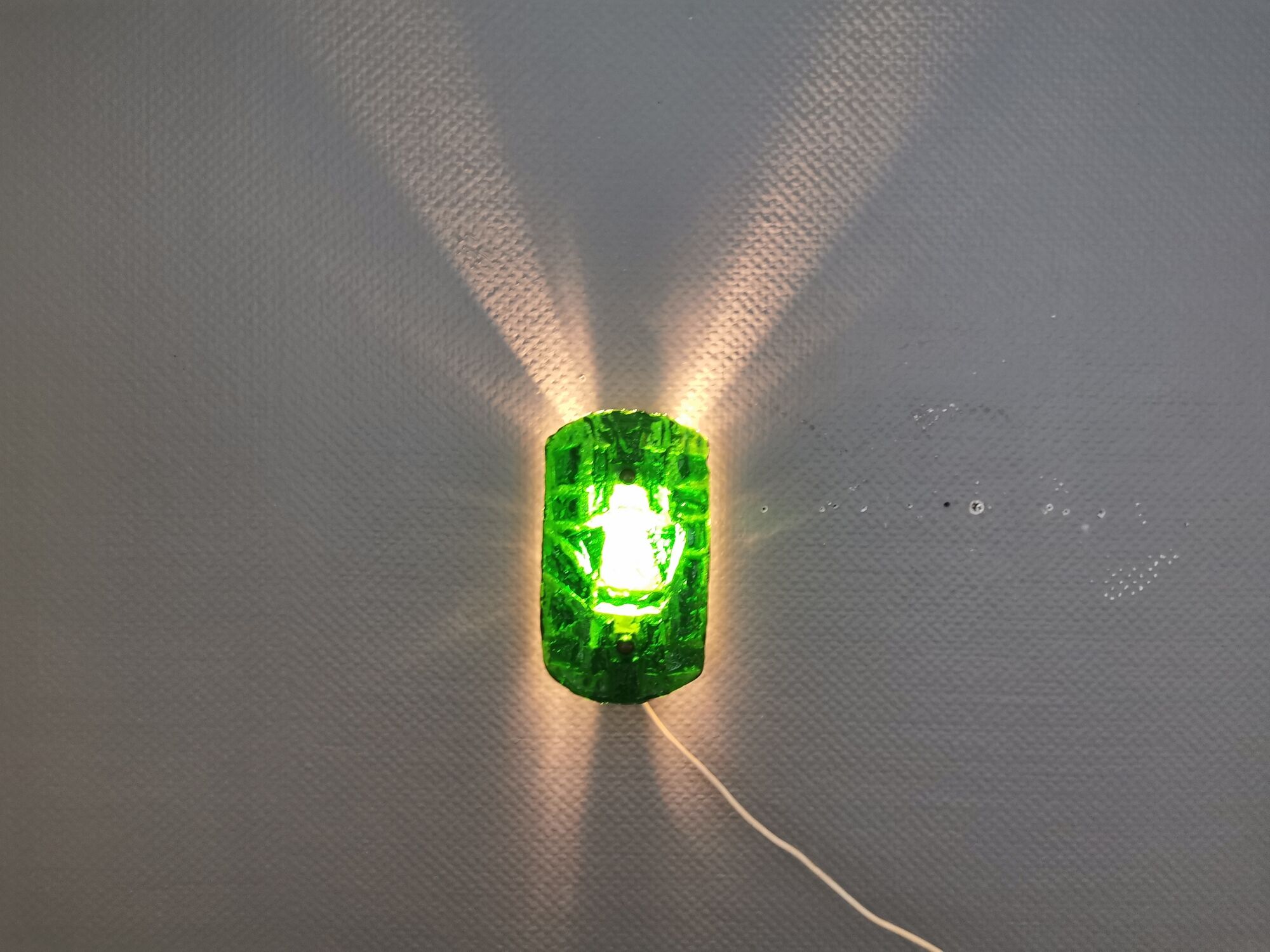 Old wall lamp made of hard pressed green glass.