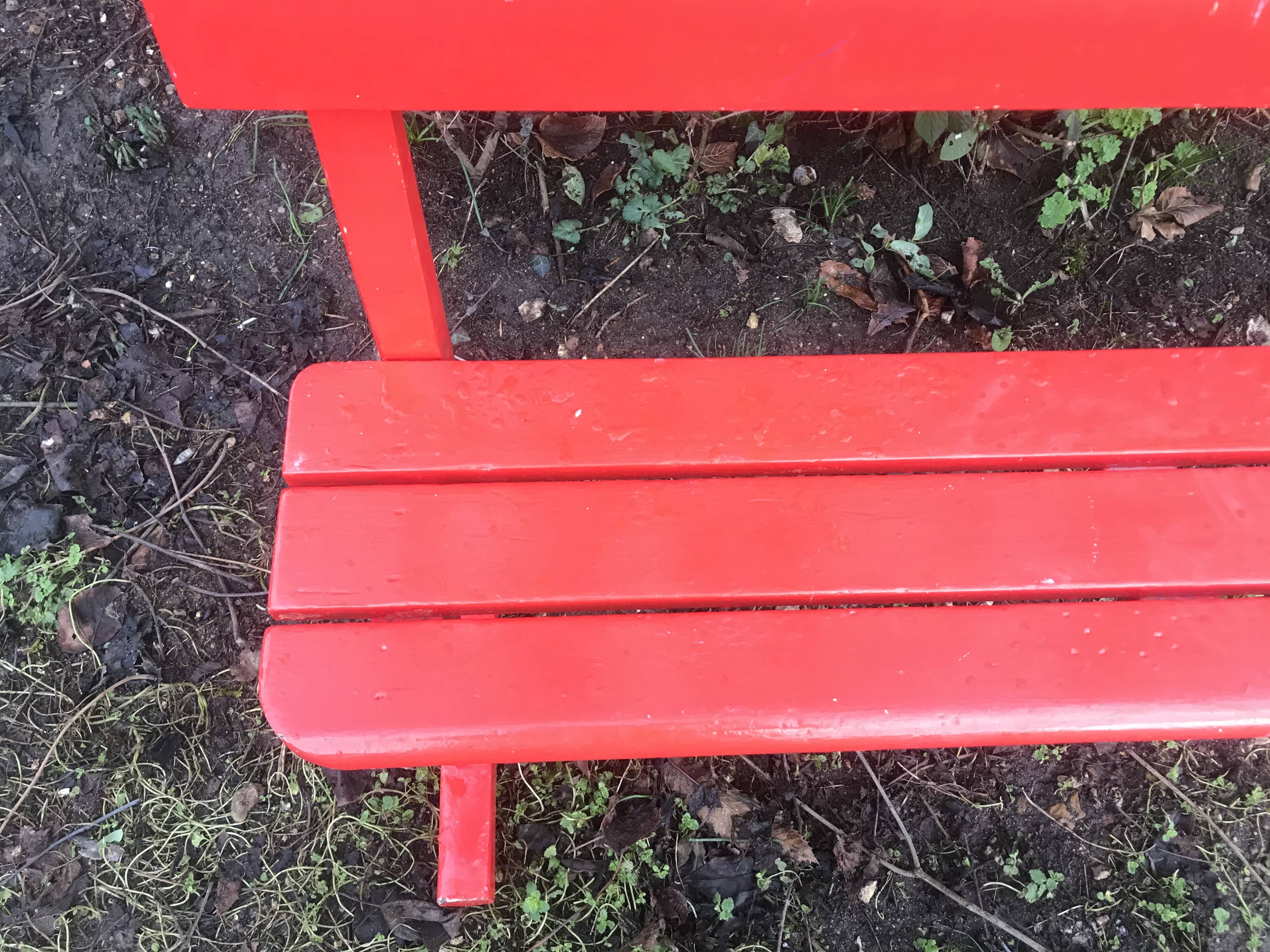 Red old schoolboy bench