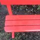 Red old schoolboy bench