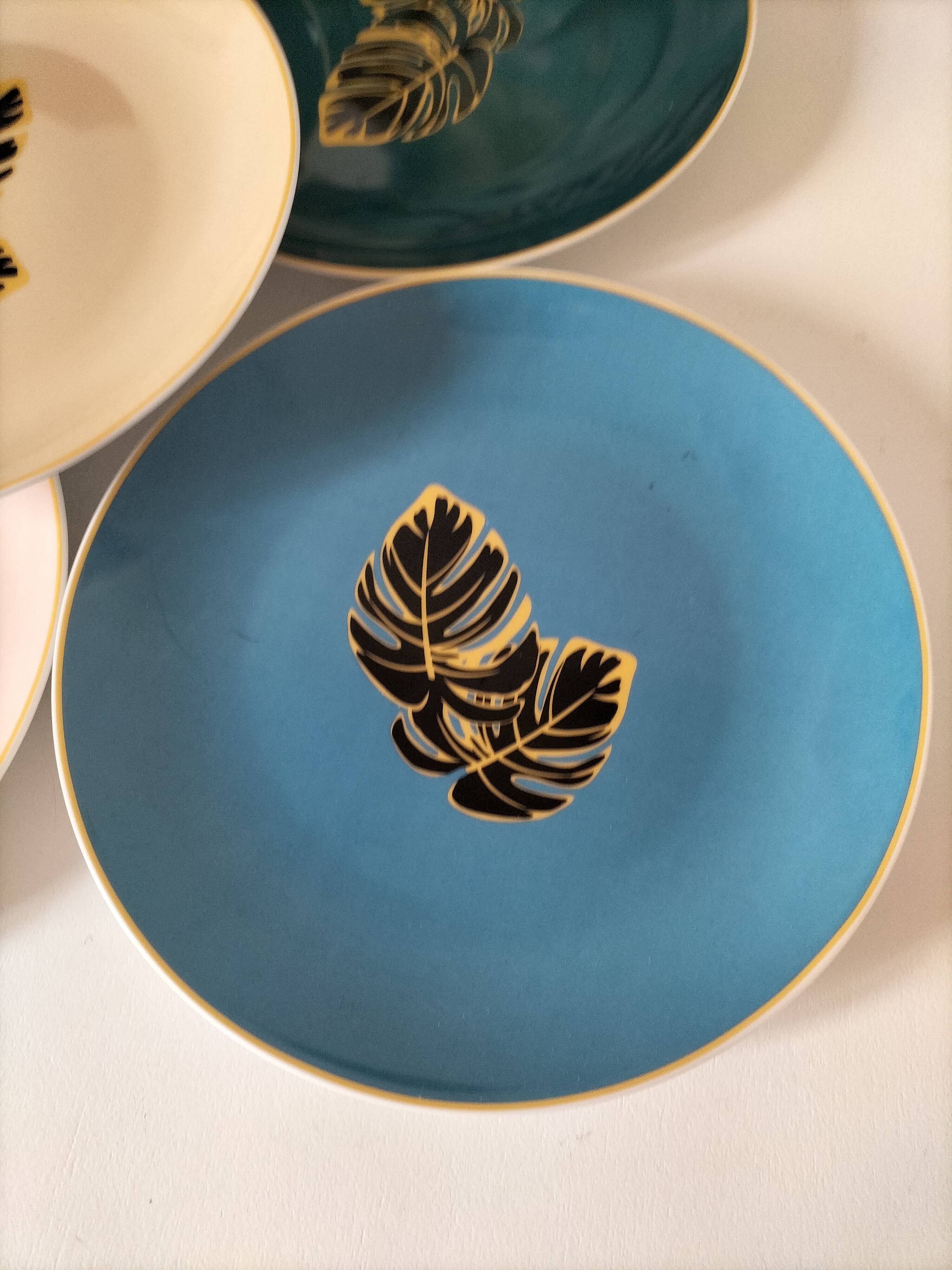 Set of 7 porcelain plates, gold foliage & jungle