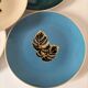 Set of 7 porcelain plates, gold foliage & jungle