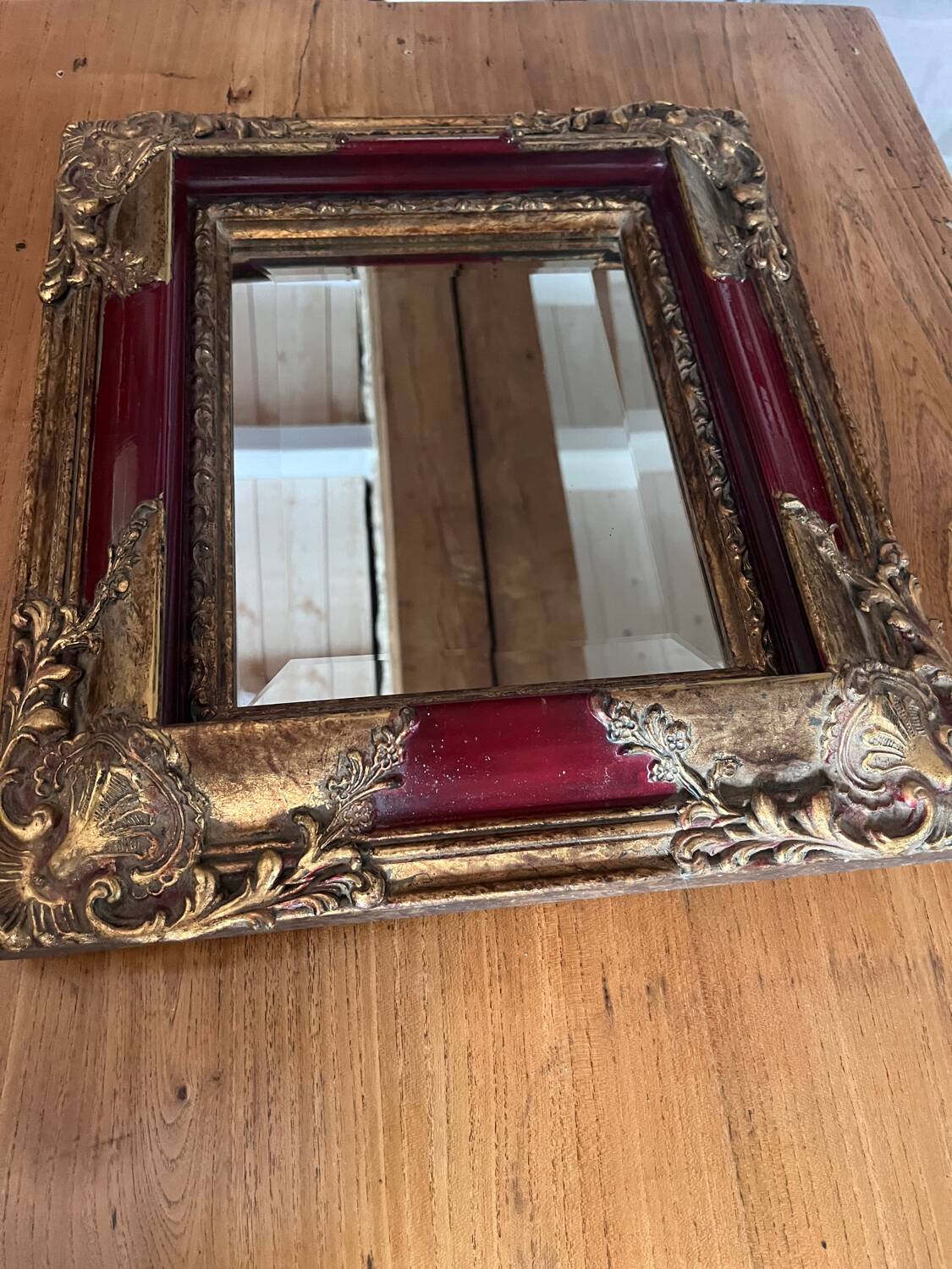 Old mirror with gold and red frame