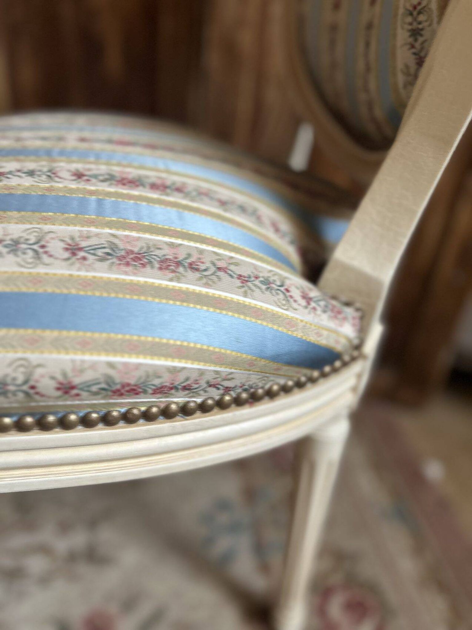 Pair of Louis XVI style chairs in painted wood and satin, classic elegance.