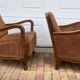 Pair of 1920s brown armchairs in carved wood and fabric, with caning detail.