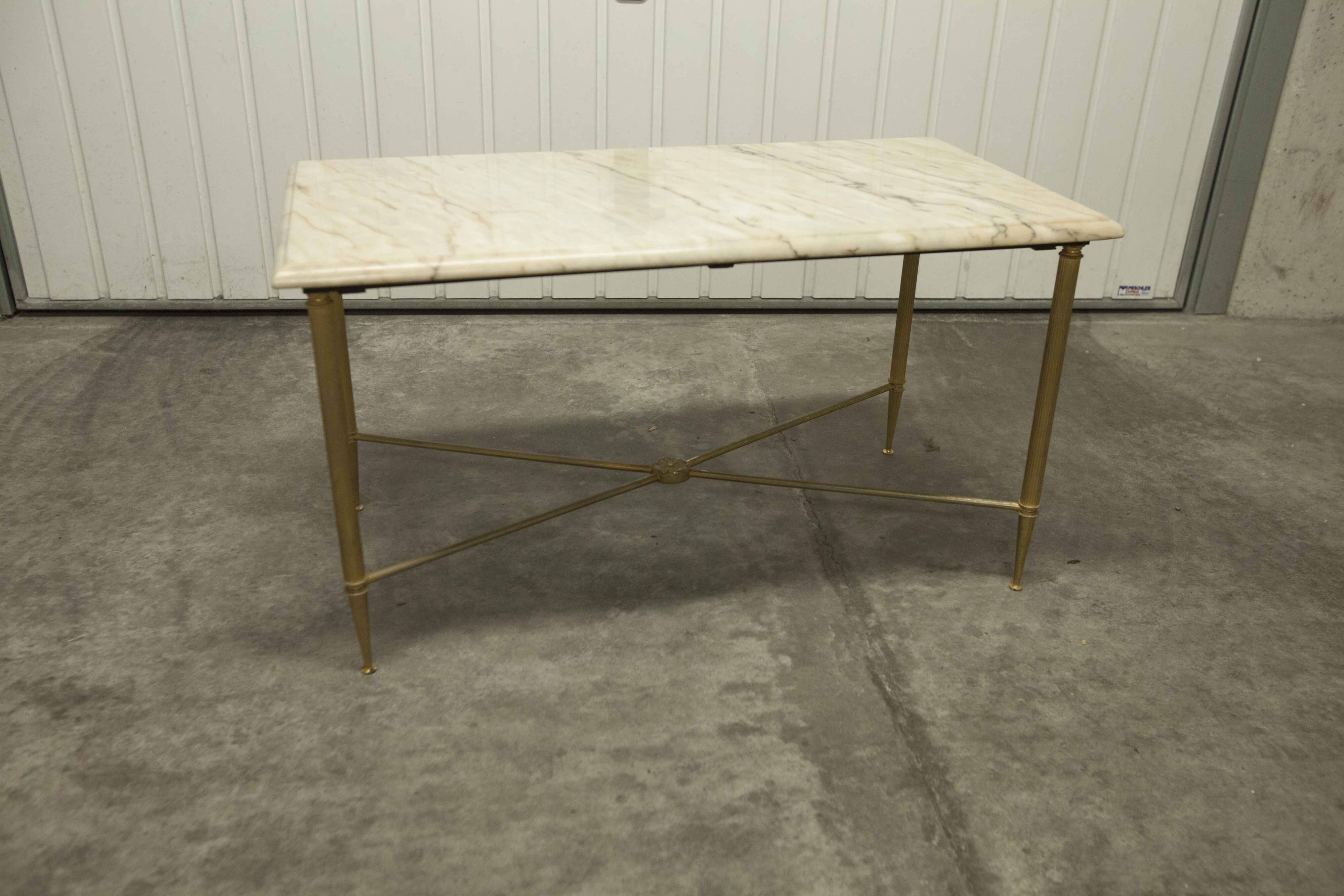 Marble coffee table with brass legs, height 46 cm.