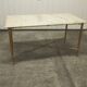 Marble coffee table with brass legs, height 46 cm.