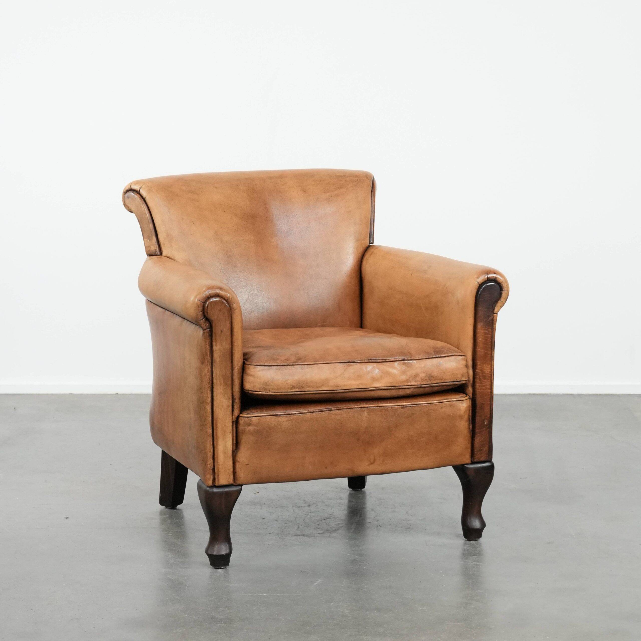 Vintage sheepskin armchair with a beautiful light colour and elegant legs