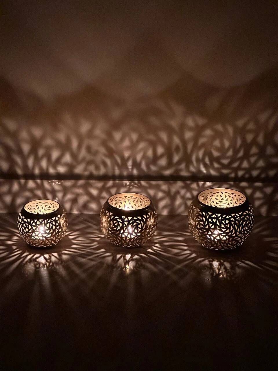 Set of 3 handmade brass candle holders with an openwork pattern.