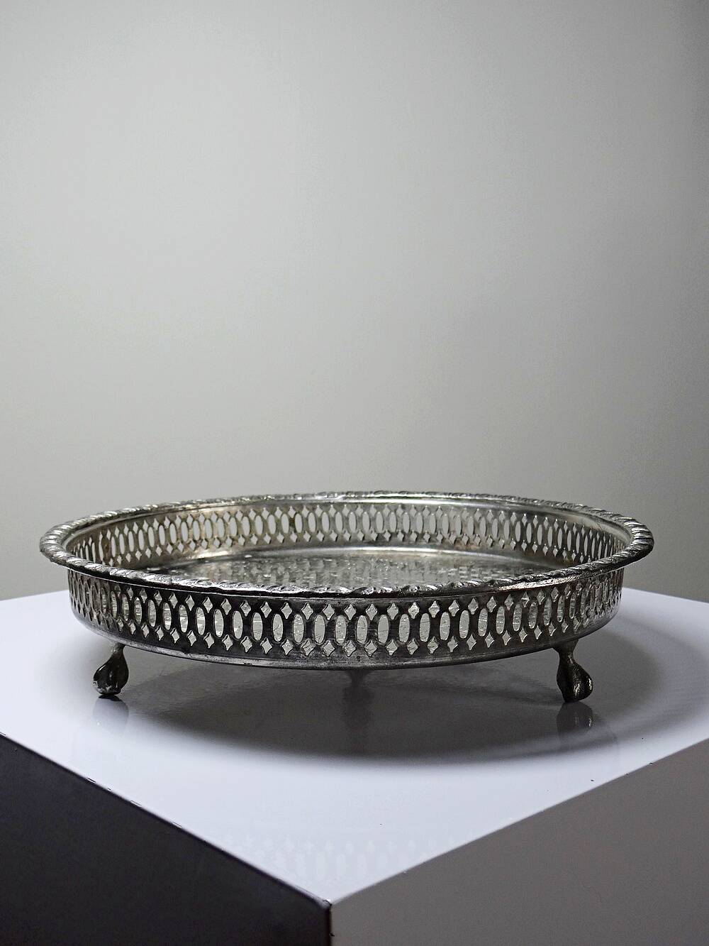 Small Moroccan tripod tea tray in silver-plated metal, vintage chiseled decoration.