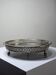 Small Moroccan tripod tea tray in silver-plated metal, vintage chiseled decoration.