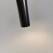 Two cylinder-shaped hanging lamps in black lacquer