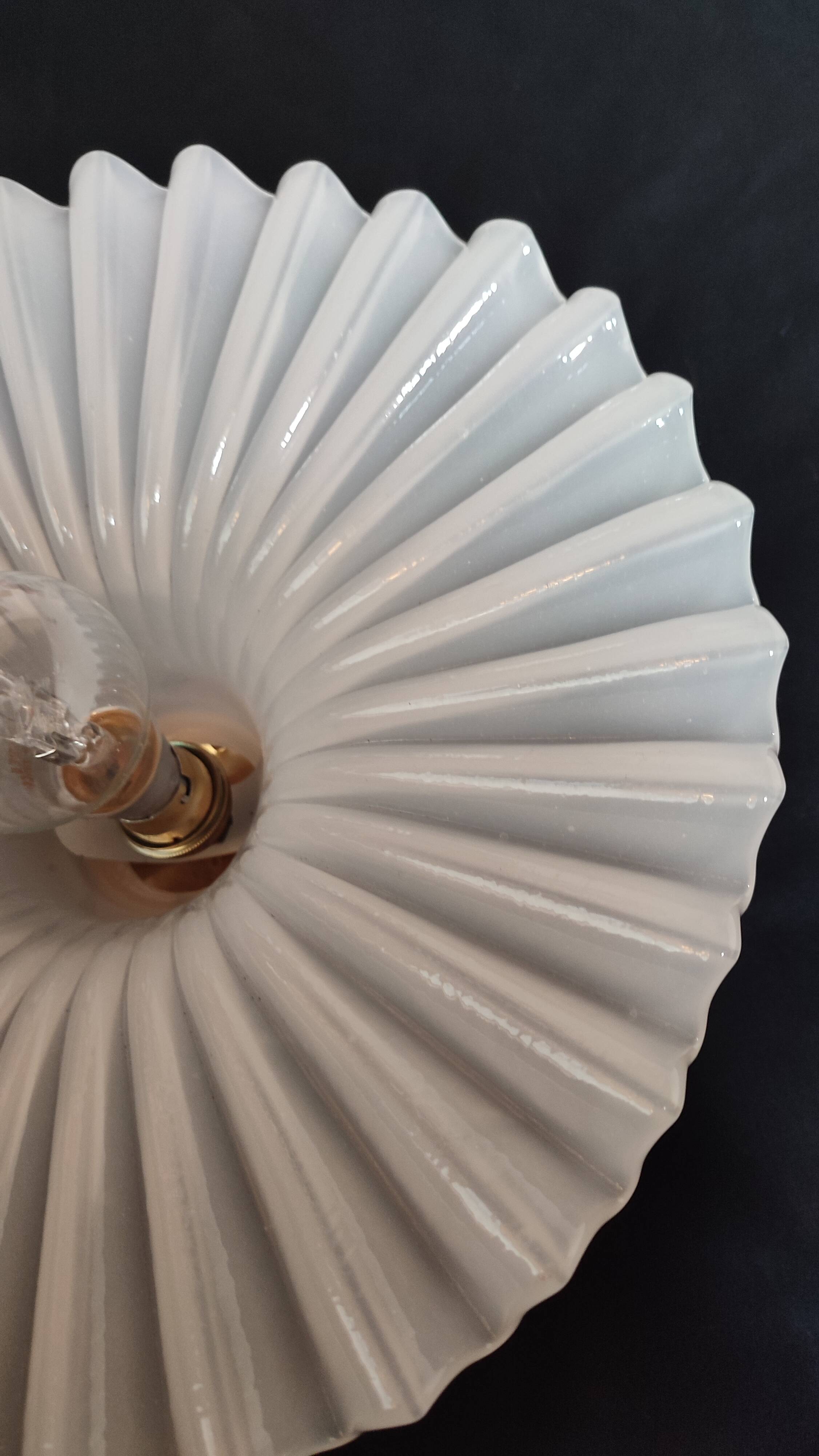 Round pendant light in pleated semi-opaque glass