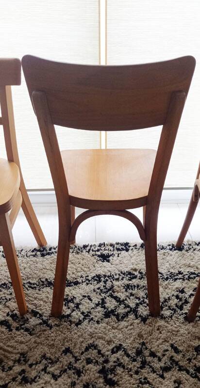Set of 4 light wood bistro chairs stamped Baumann and Thonet.