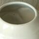 Thick white porcelain vase with relief decoration of a flying duck.