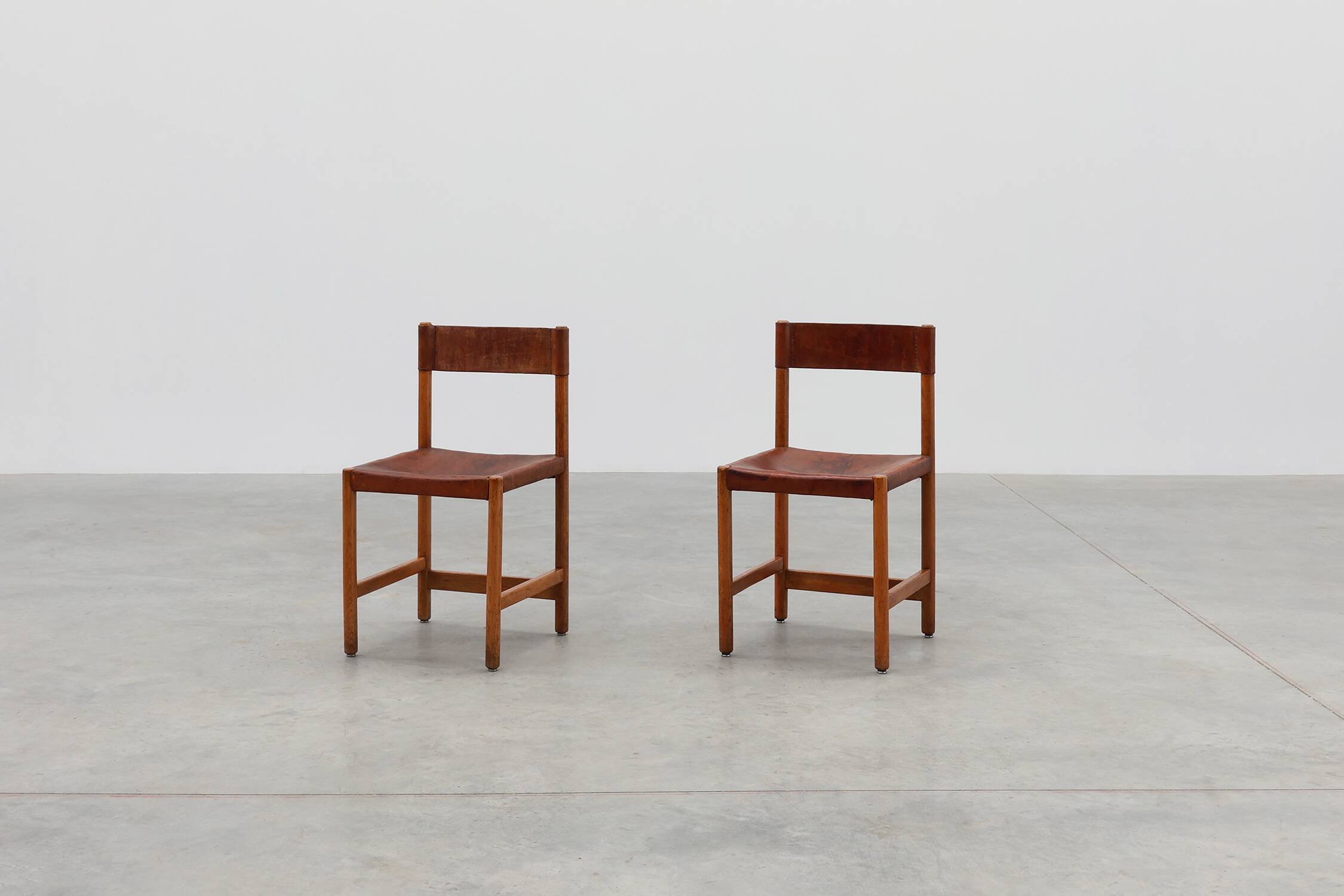 Pair of wood and leather Spanish chairs by Jordi Vilanova, ca. 1960
