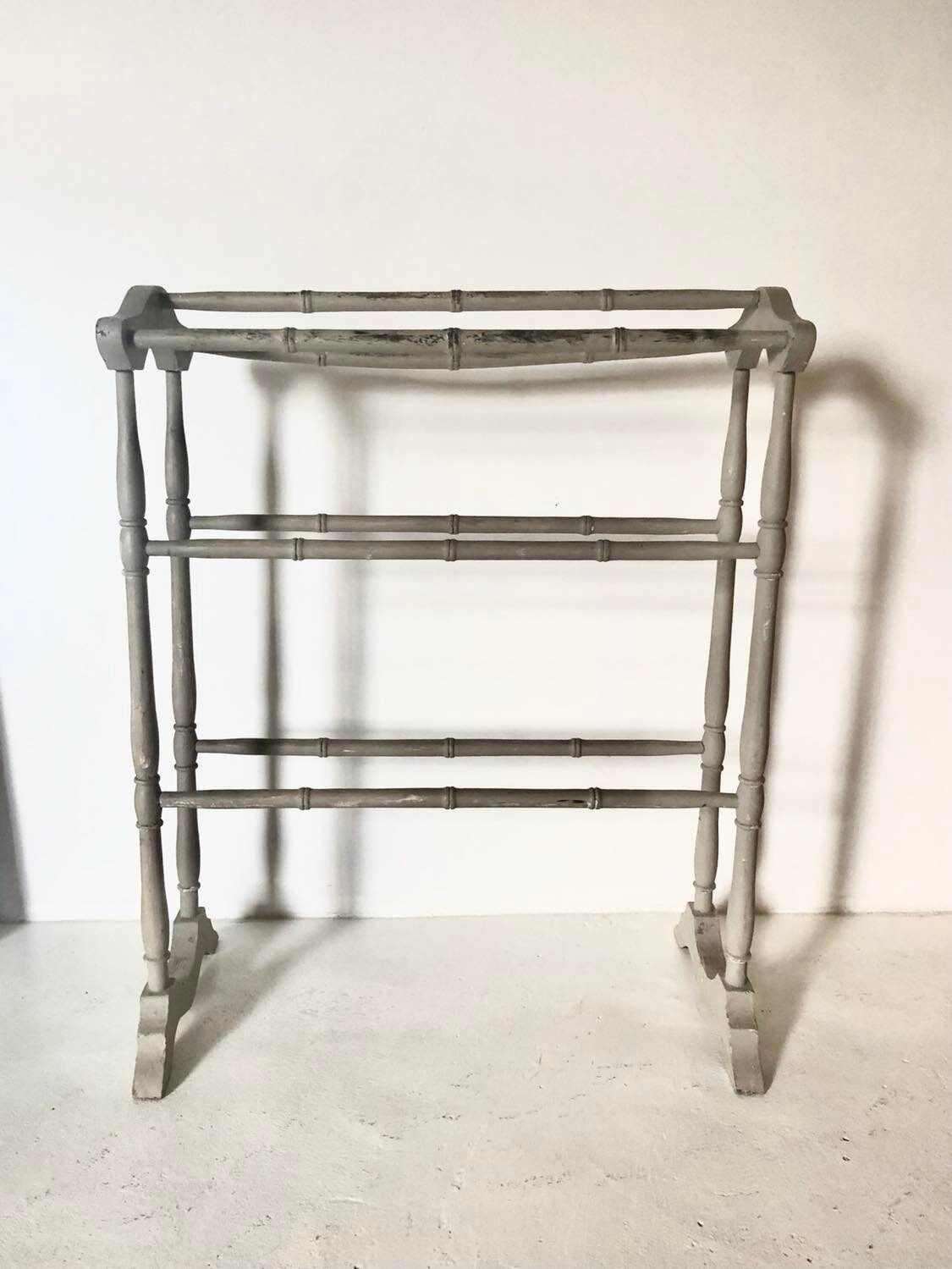 Old bathroom towel rack in patinated wood