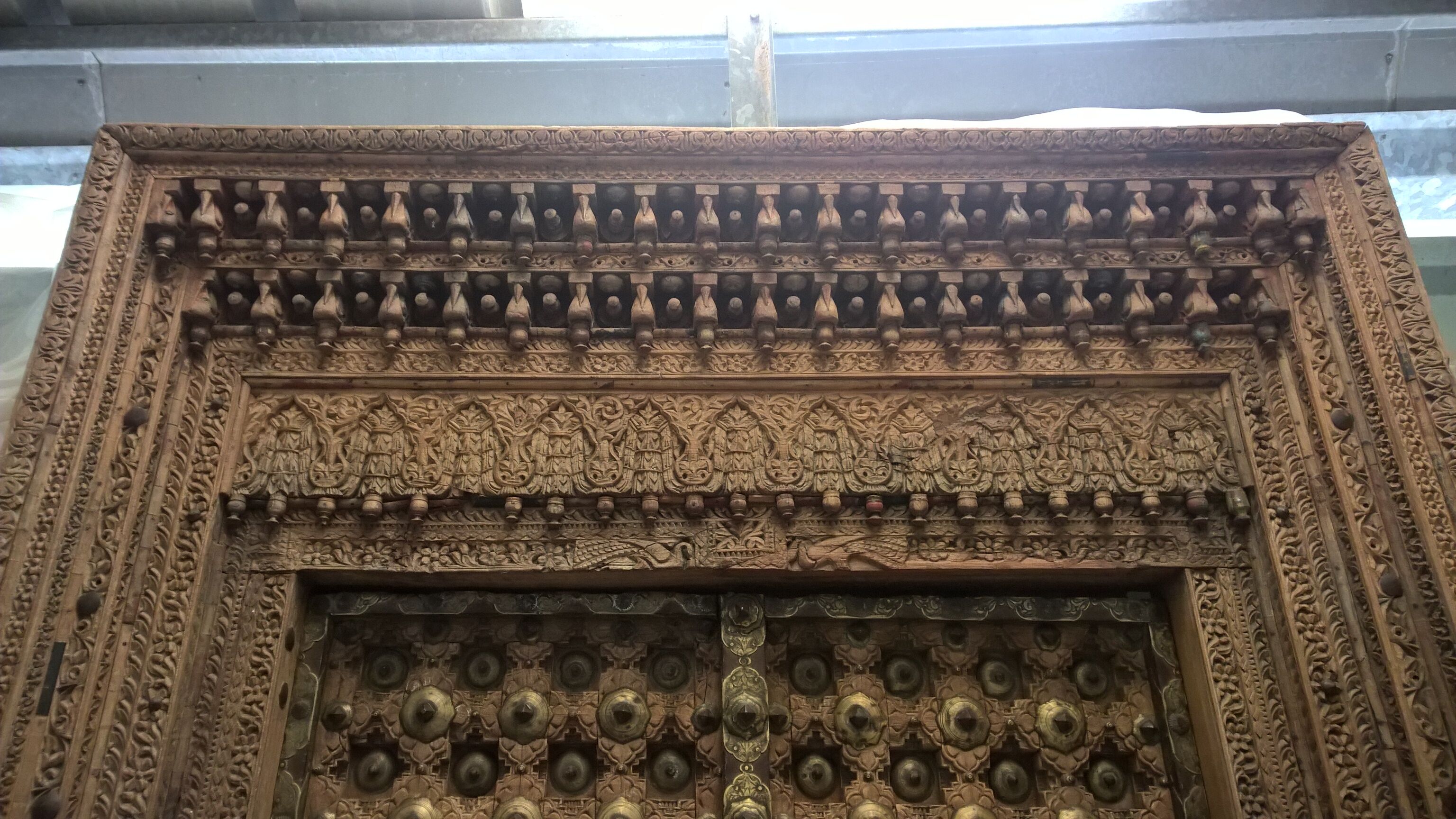 Old crafted teak and brass door