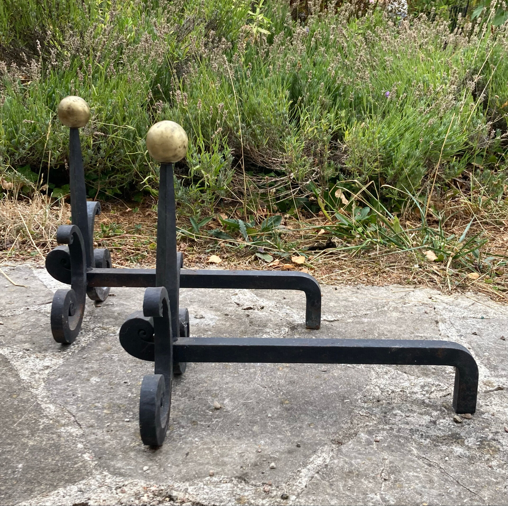 Massive wrought iron chenets from the 19th century topped with brass balls.