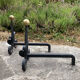 Massive wrought iron chenets from the 19th century topped with brass balls.