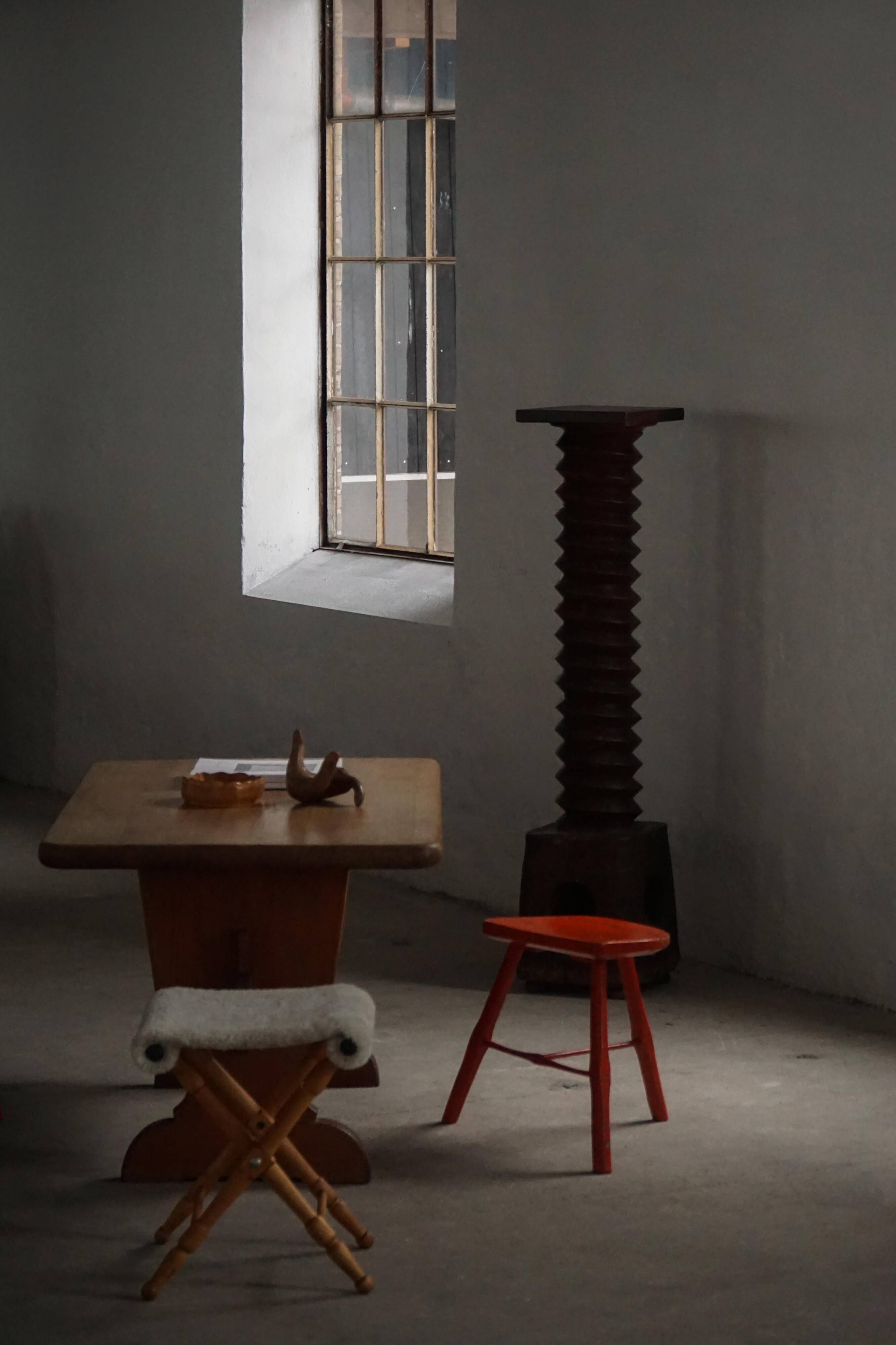 Pair of patinated wooden stools painted red with flared legs, 1950s-1960s.