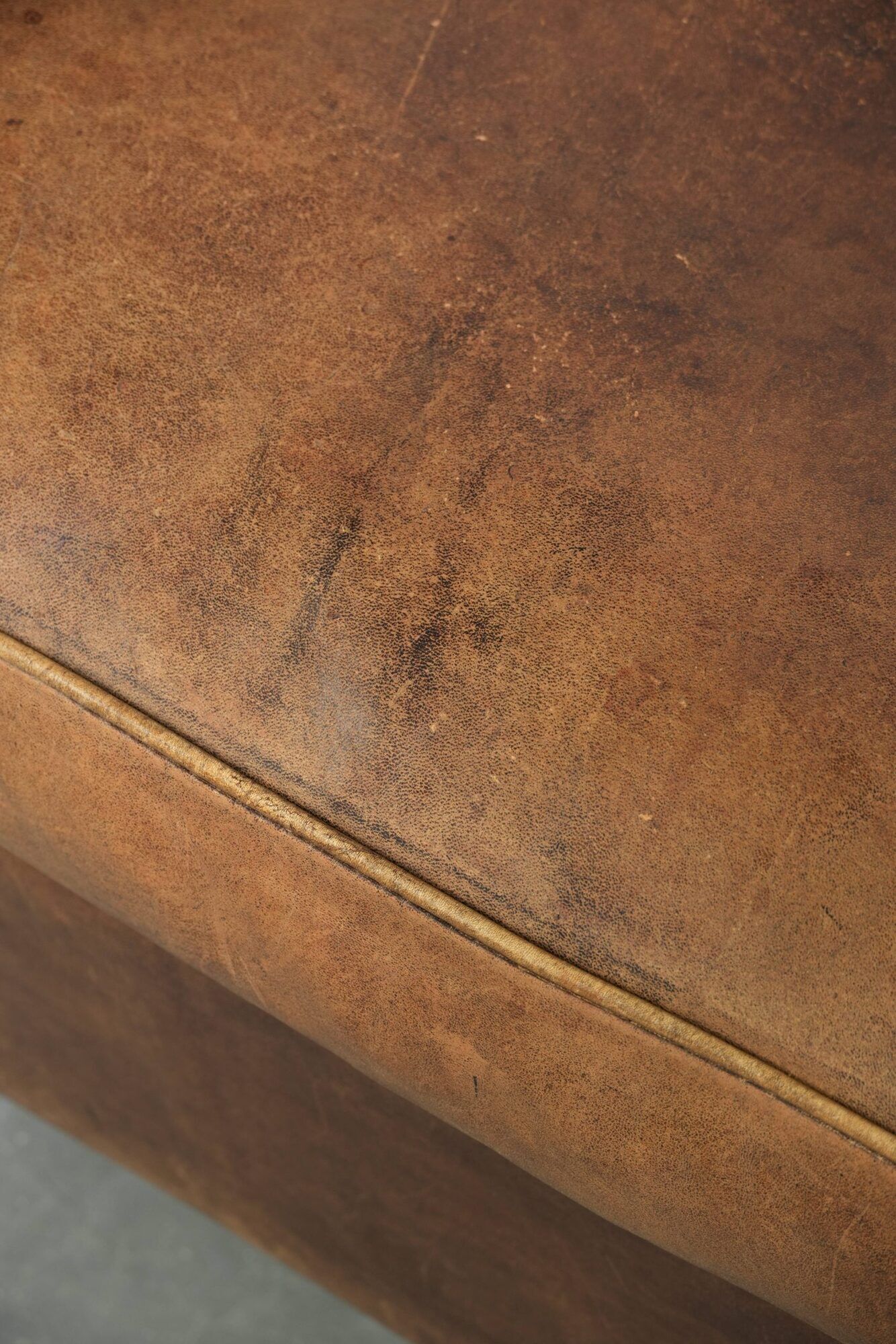 Sheepskin armchair in a light cognac colour with matching piping
