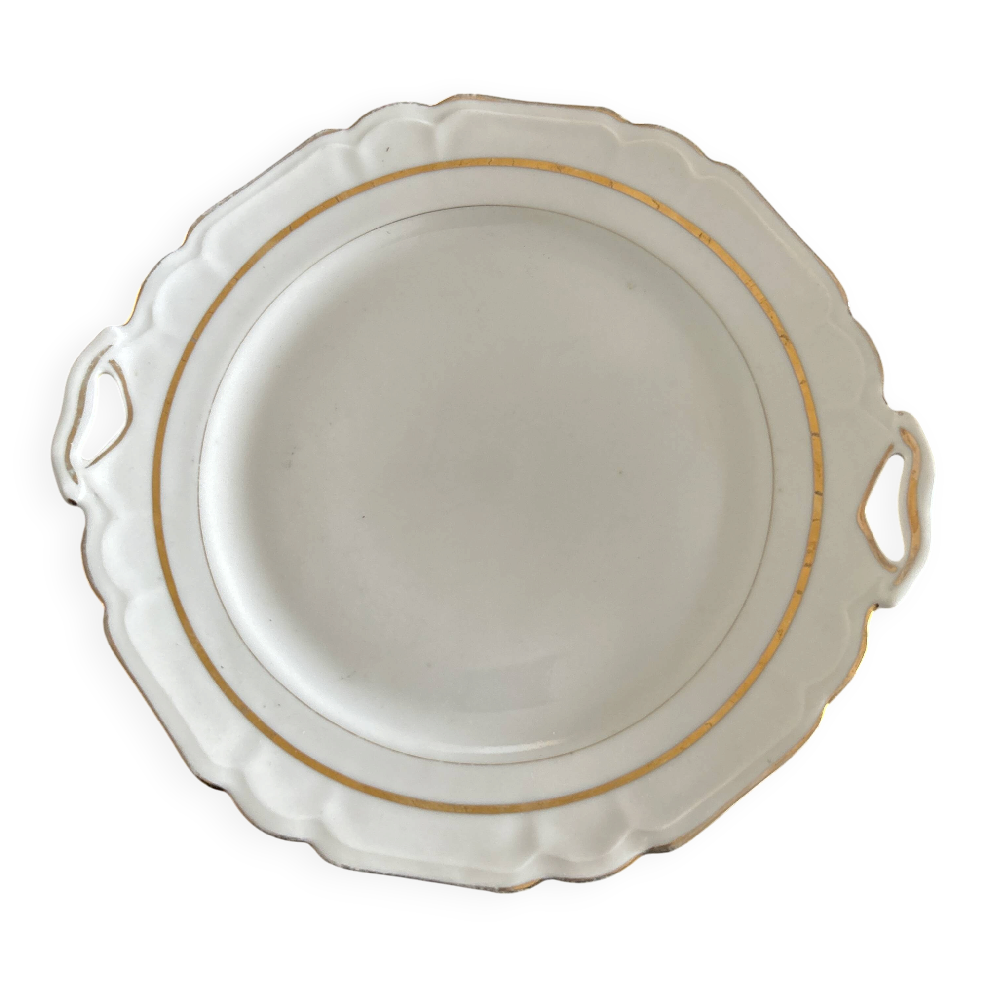 This dish appears to be a serving dish or a round plate with handles made of porcelain.