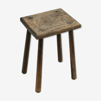 Old wooden stool with log feet