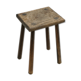 Old wooden stool with log feet