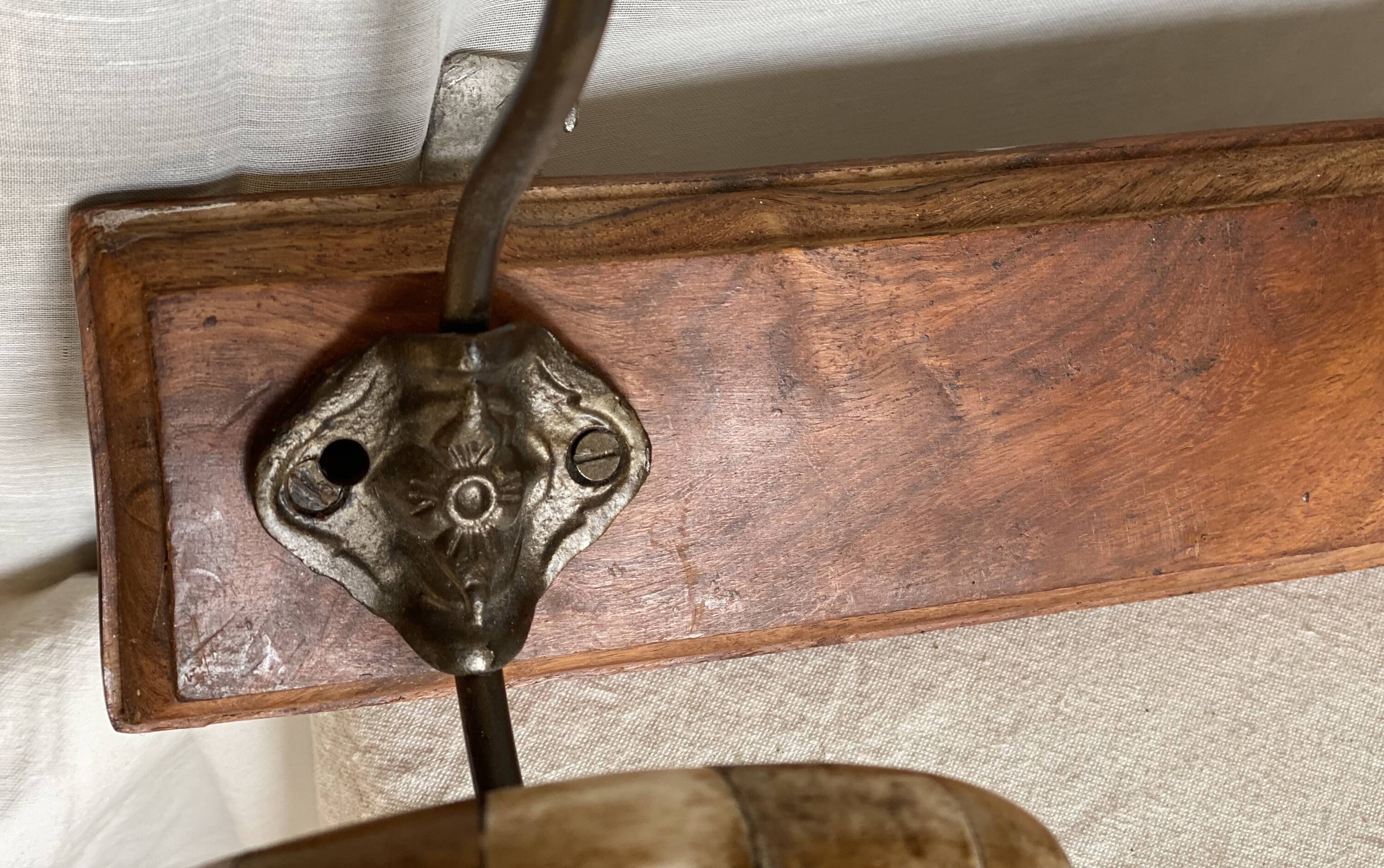 19th-century wall coat rack with 2 metal and horn hooks.