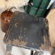Solid wood stool with a worn black patina.
