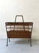 Black wrought iron and rattan magazine rack by Raoul Guys, 1950.
