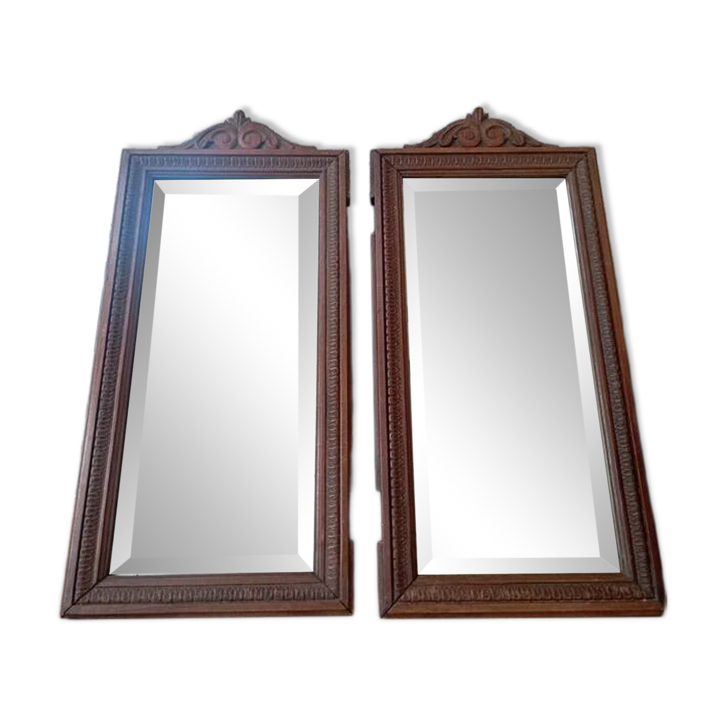 Set of two bevelled mirrors in moulded oak.