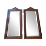 Set of two bevelled mirrors in moulded oak.