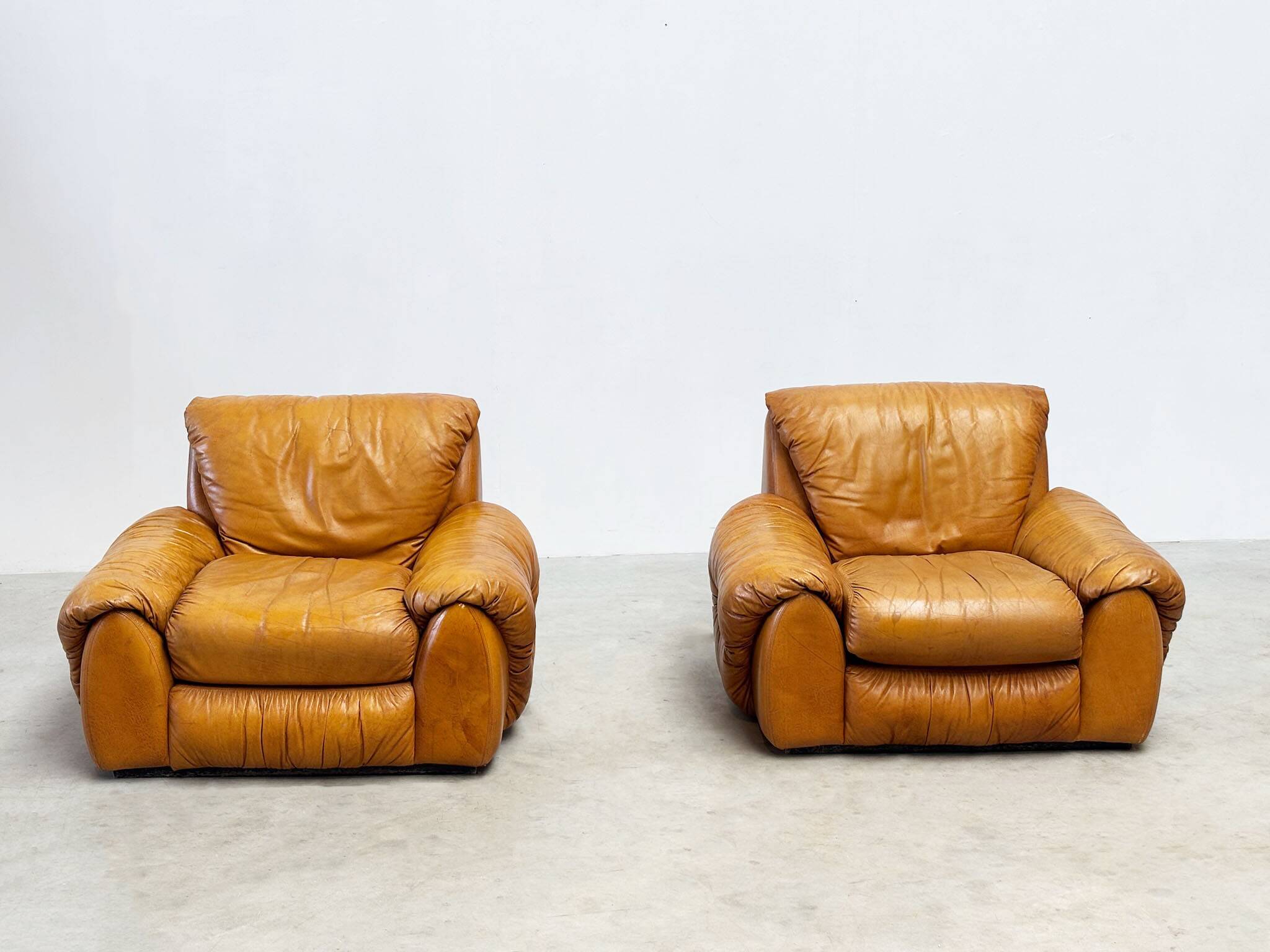 Set of two Italian cognac leather lounge chairs