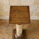 Wood and lacquer pedestal column table mimicking marble, 19th century.