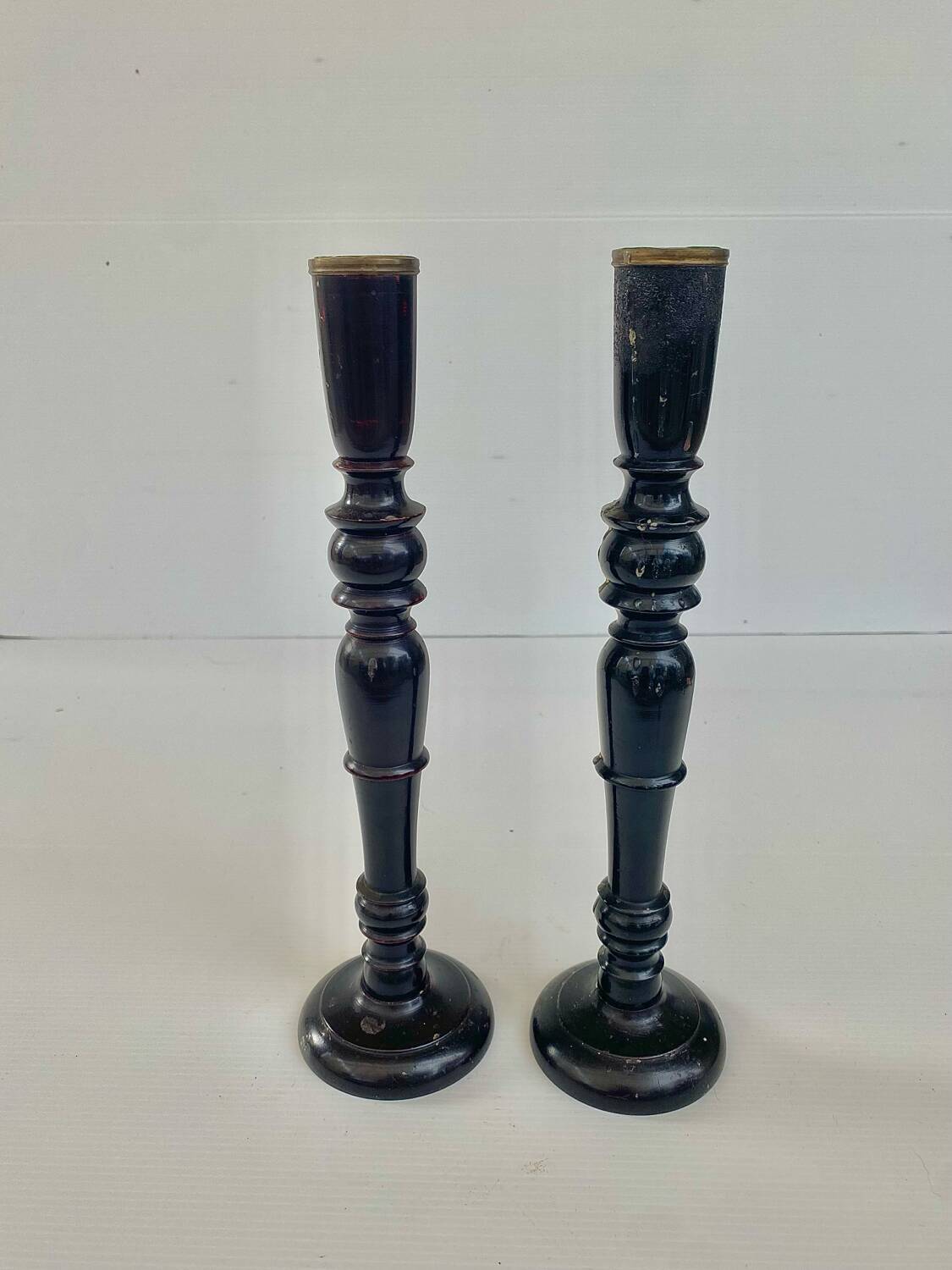 Pair of antique ebonised wooden candlesticks from the 19th century.
