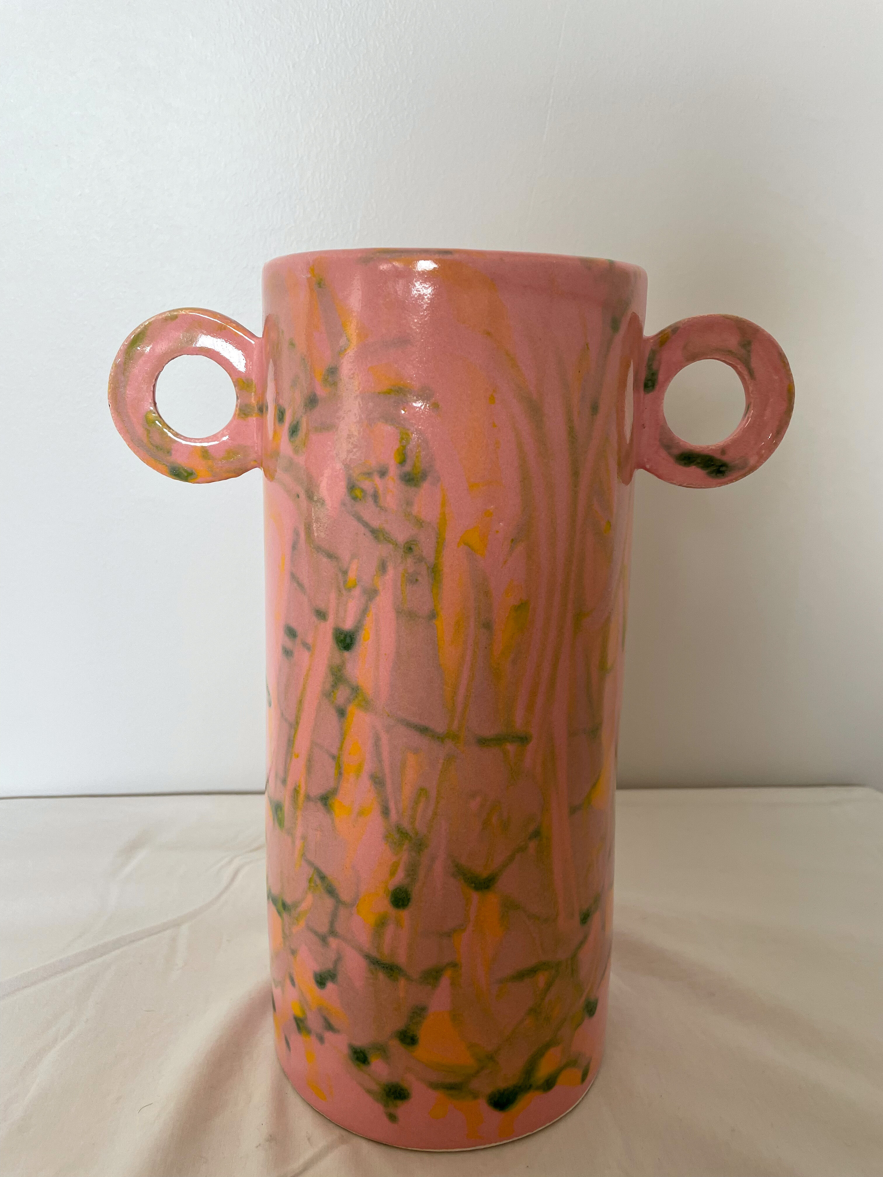 Pink ceramic vase with abstract circular handles
