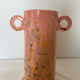 Pink ceramic vase with abstract circular handles