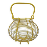 Old yellow painted metal egg basket