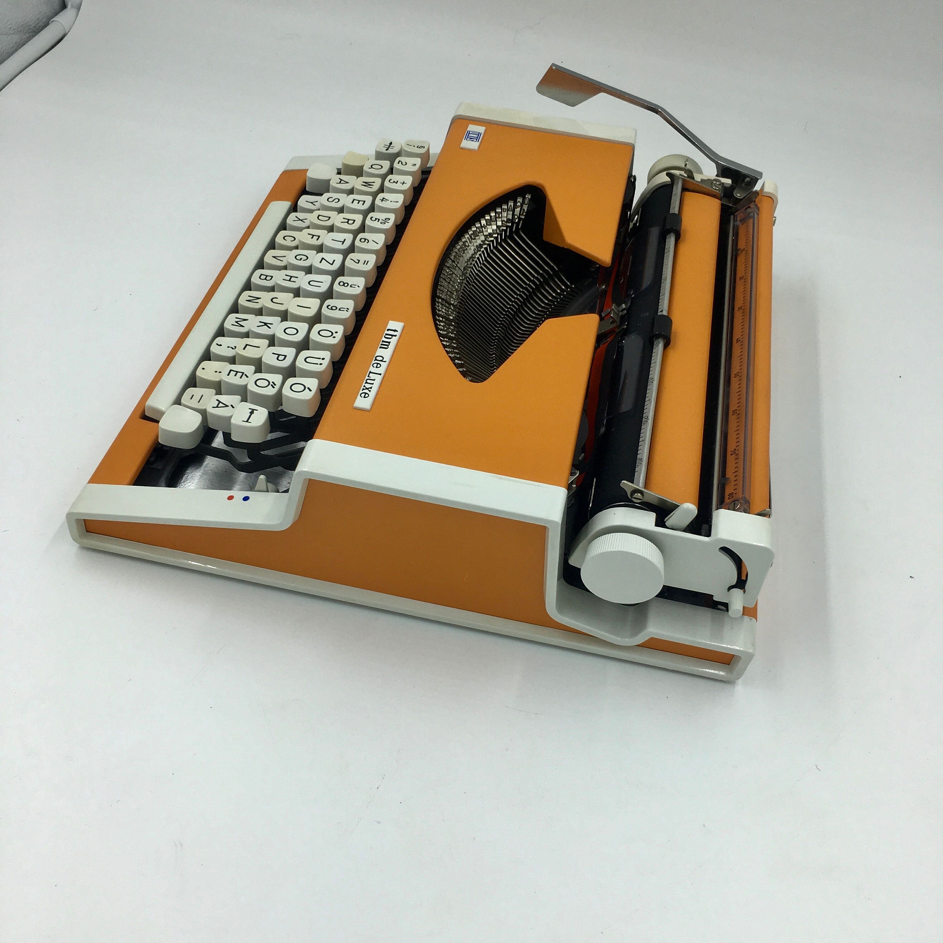 WE typewriter orange