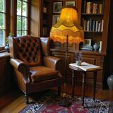 Vintage gold floor lamp with fringed shade.