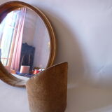 Round mirror on inclined cylindrical support