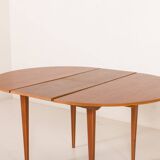 Scandinavian round teak table with hidden extension, 1970s