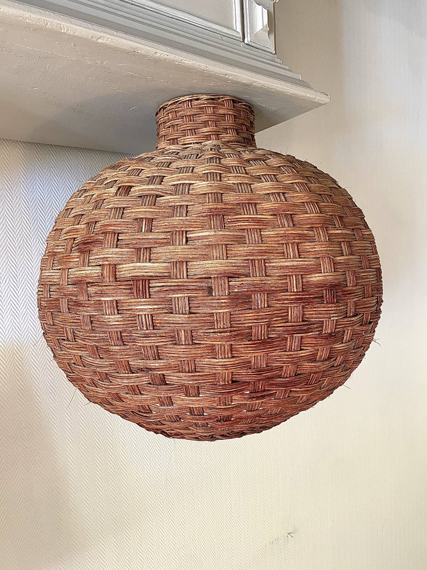 Large vintage lampshade made of hand-woven rattan.
