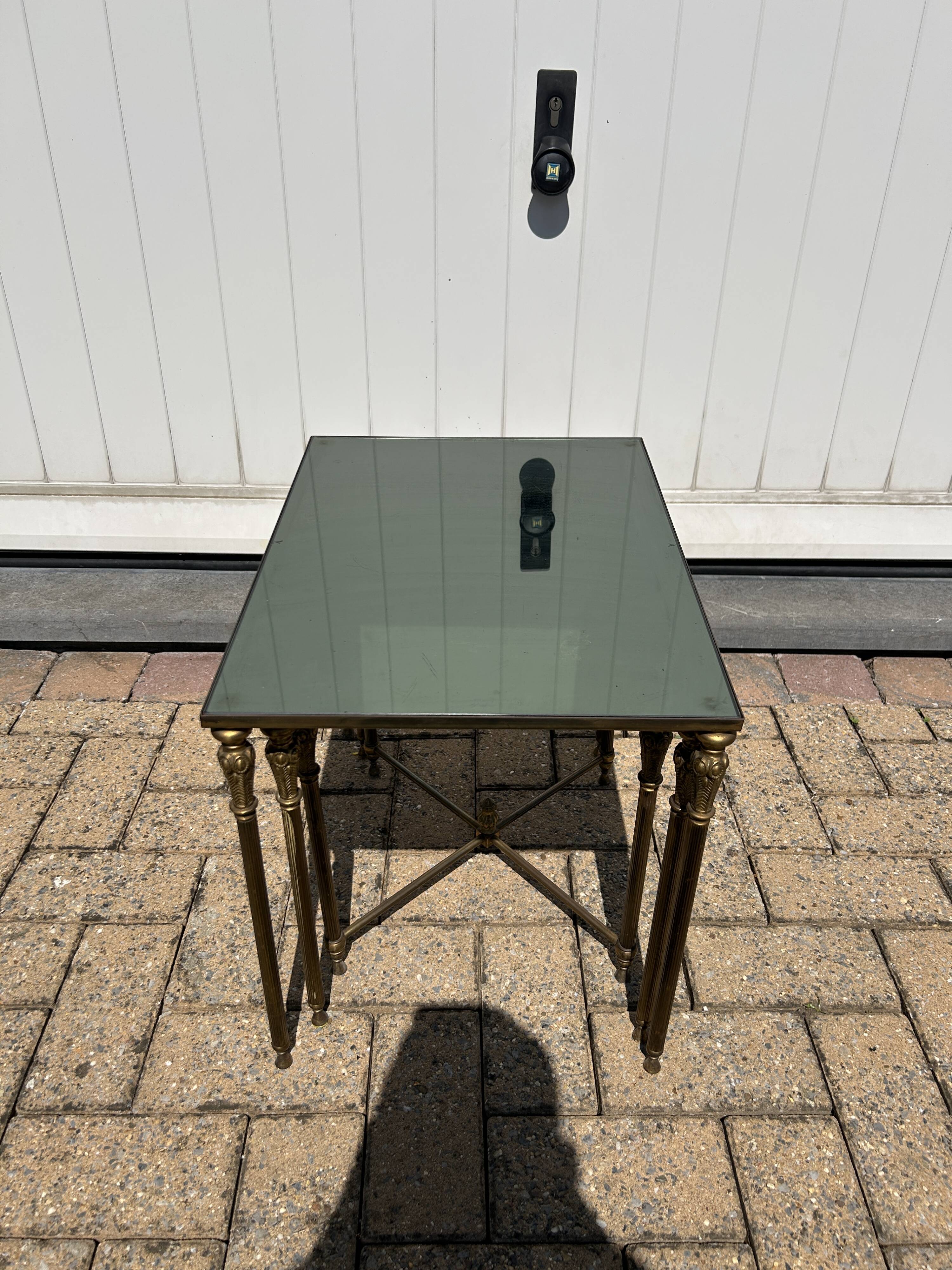 Nested tables in gilded brass in the style of Maison Charles.
