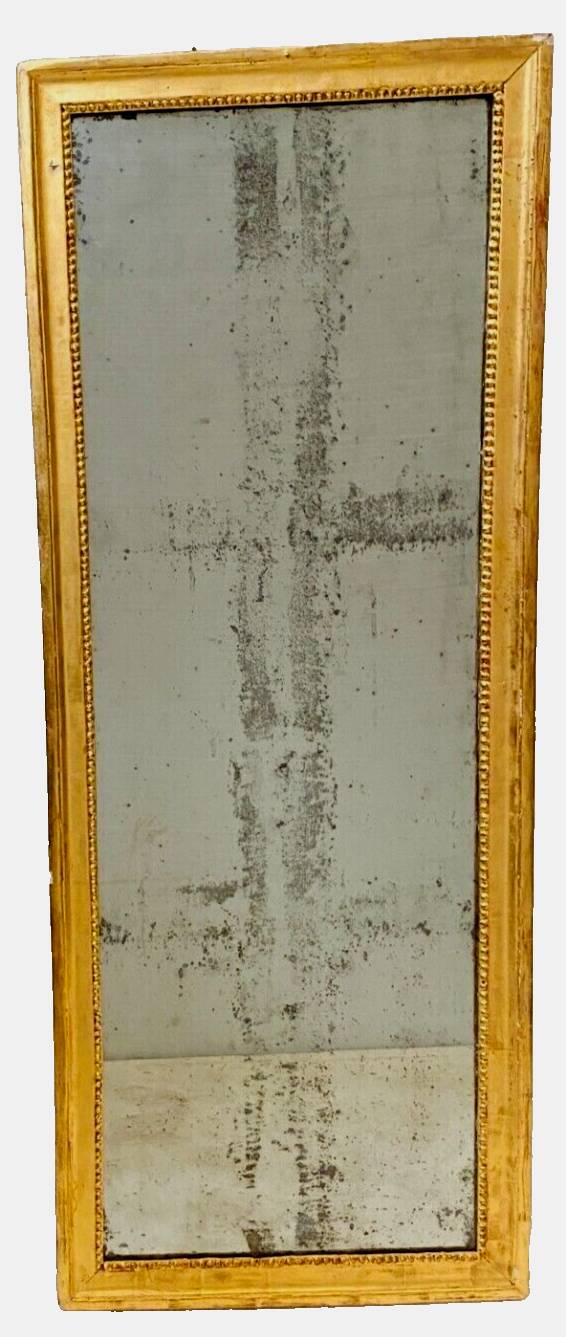 Louis XVI mirror in carved and gilded wood with leaf 18th century