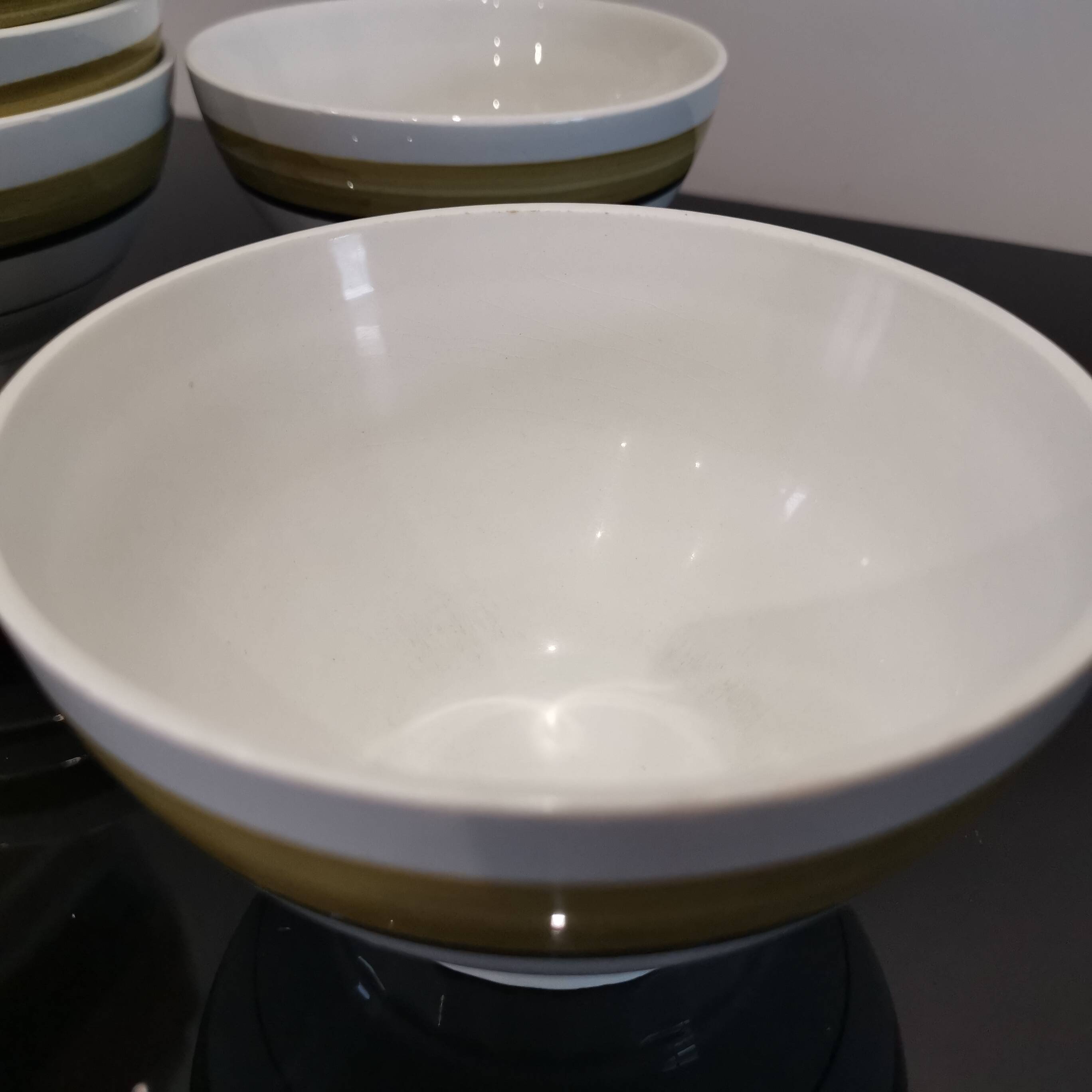 Series of 5 small old earthenware bowls with olive green edging