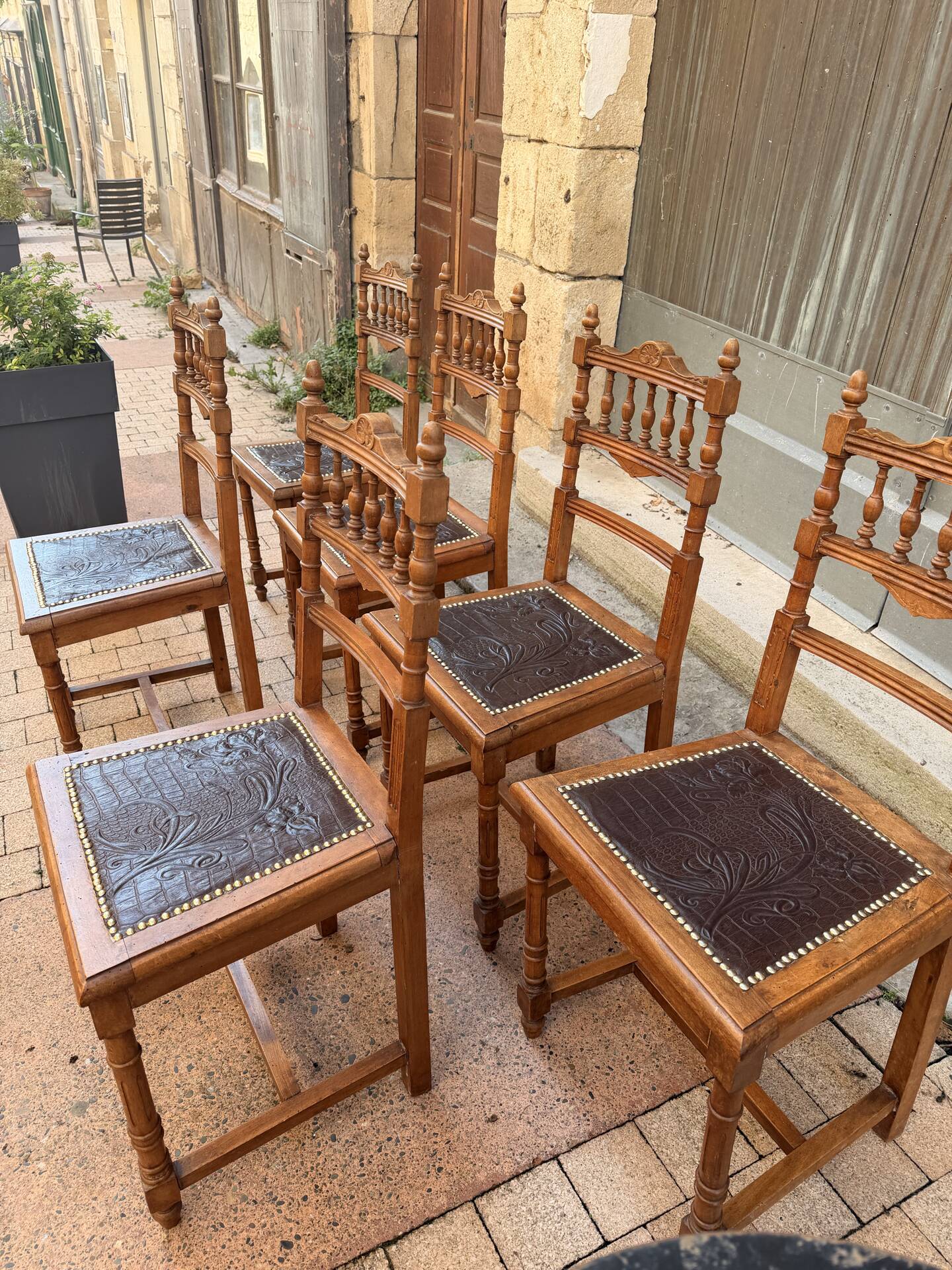 Set of 6 antique turned wooden chairs with embossed leather seats.
