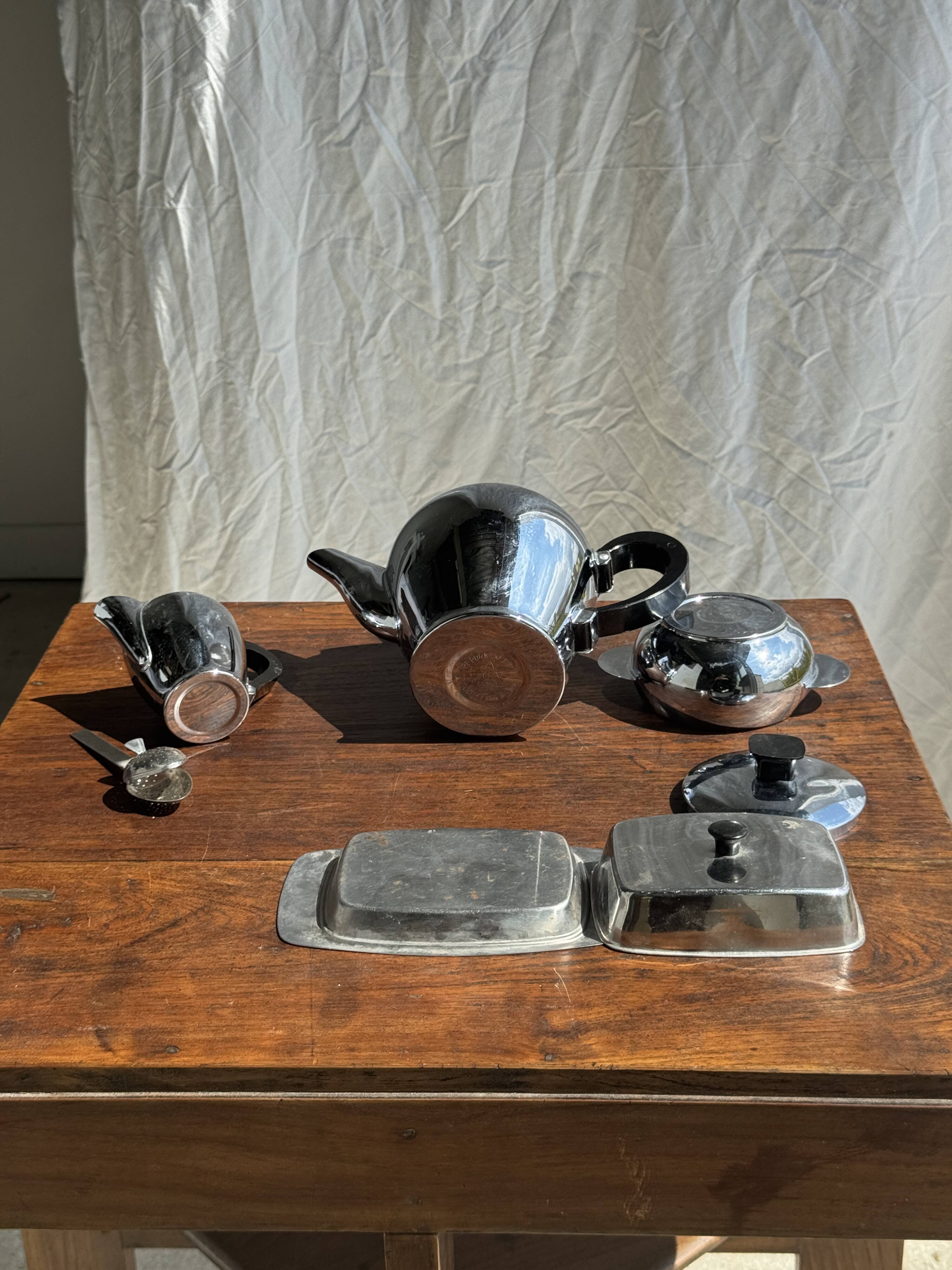 Tea set including teapot, milk jug, sugar bowl and butter dish